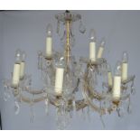 A French cut glass twelve branch chandelier, adorned with faceted beads and pear drops, 86cm