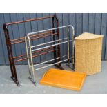 A chrome towel rail, a wicker linen basket, a wooden rail and a tray.