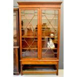 A 19th century mahogany glazed bookcase, with height adjustable shelves, raised on a base with