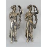 A pair of silver plated female figurines holding floral swags, 14cms tall