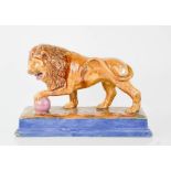 A Victorian Majolica performing lion figure. Standing on rectangular plinth base with mottled glazes
