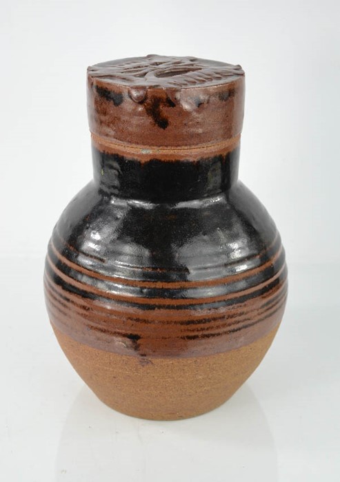 A Studio ware stone glazed bottle and cover, the cover embossed with design. 28.5cm