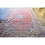 A red ground antique Kashan rug, 250 by 378cm