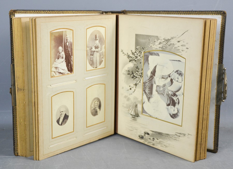 A Victorian postcard album, containing family portraits, leather bound.