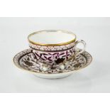 A 19th century German porcelain cup and saucer, decorated with purple flowers and gilded highlights,