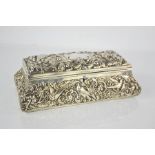 A silver glove box by Williams Comyns, 1905, embossed with birds, foliage and scrollwork, with