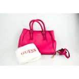 A pink leather Guess handbag with original outer cloth.