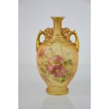 A Royal Worcester blush ivory vase, with twin handles and painted with wild flowers, 22.5cm high.