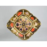 A Royal Crown Derby 1128 pattern Imari diamond shaped dish on four scroll feet, with scroll