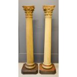 A pair of 19th century fluted architectural columns, with painted capitals, fluted column and raised