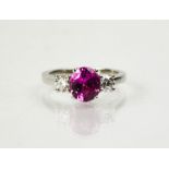 A platinum, pink sapphire adn diamond ring, the sapphire 2.20cts, flanked by diamonds totalling 0.