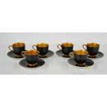 A set of six Royal Worcester coffee cups & saucers, in matt black and gilded interiors, date mark