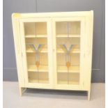 A 1960s glazed cabinet, painted and having leaded decorative glass panels.