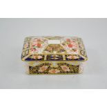 A Royal Crown Derby square shaped box and cover, date code 1913, on four feet 7cm high.