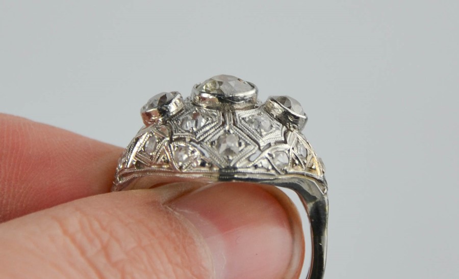 An Art Deco diamond and platinum ring, the central diamond approximately 0.8cts, flanked by two - Image 7 of 8