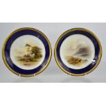 A pair of Royal Worcester dishes painted with cattle by John Stinton, with cobalt blue borders, date