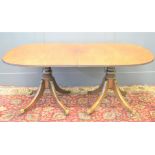 A 19th century mahogany twin pedestal dining table with baluster columns and splayed legs and