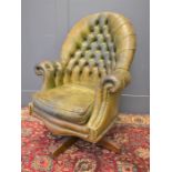 A Raphael Colome button back armchair, with swivel base.