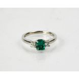 A platinum, emerald and diamond ring, the emerald approximately 0.66cts, and the diamonds