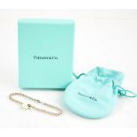 A silver Tiffany & Co beaded bracelet, with the original drawstring bag and box.
