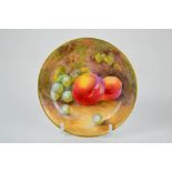 A Royal Worcester shallow circular tray and painted with fruit, signed Nicholls, date code 1954,