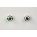 A pair of 18ct white gold, diamond and emerald earrings, the emeralds totalling 0.45ct, the diamonds