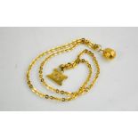 An 18ct gold chain link necklace with nut form pendant and fob, 20.4g.