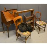 A group of furniture to include a small bureau, two Victorian chairs, and two bookcases.