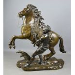 A 19th century bronze horse and handler, signed Colston, on a rocky base, 57cm high.