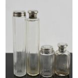 Four silver topped glass dressing table bottles.