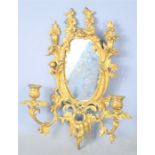 A 19th century French gilt bronze wall sconce with mirror