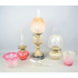 Three Victorian oil lamps together with three vintage glass light shades