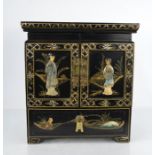 A 20th century Chinese jewellery casket with cupboard doors revealing four silk linked drawers and a