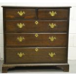 A Georgian oak chest of drawers, with two over three long graduated drawers, raised on bracket feet.