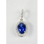 An 18ct white gold, blue sapphire and diamond pendant, the oval cut sapphire approximately 7.19ct,