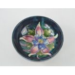 A Moorcroft pottery pin dish, floral design, 9cm