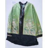 A Japanese green silk kimono, embroidered with dragons.