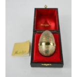A Stuart Devlin silver gilt surprise egg, London 1978, the interior opening to reveal an enamelled
