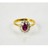 An 18ct yellow and white gold pink sapphire and diamond ring, the pink sapphire approximately 0.