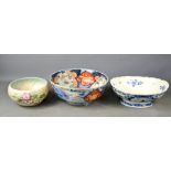 An Imari 19th century bowl, a Clarice Cliff bowl and a Delft blue and white example.