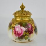 A Royal Worcester pot pourri vase and cover, painted with panel of roses, and pierced cover date
