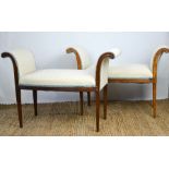 A pair of Edwardian mahogany window seats with scroll arms and tapering legs, cream and blue