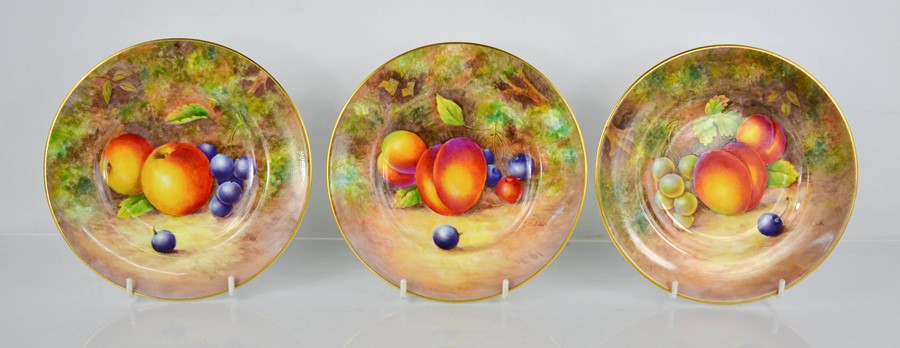 A fine set of three Royal Worcester plates, painted with apples, blackberries, peaches, by J Cook,
