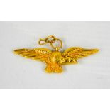 A gold (unmarked) pendant in the form of a bird with outspread wings, 4.6g.