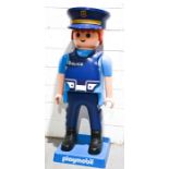 A full size Playmobile shop advertising display model of a Policeman.