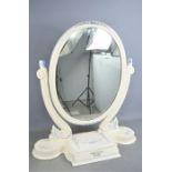 A Victorian toilet mirror painted white with flowers