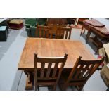 A 17th century style oak draw-leaf table with large turned cup and cover legs and four dining