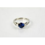 A platinum, sapphire and diamond three stone ring, the sapphire 1.5ct, and the diamonds totalling