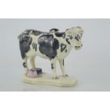An early 19th century Staffordshire cow creamer, circa 1810, with original stopper.