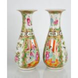 A pair of 20th century Chinese Canton vases, painted with panels of birds and figures, 22cm high.